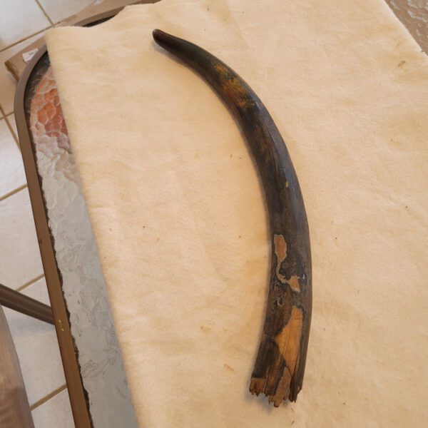 A piece of wood with some brown paint on it