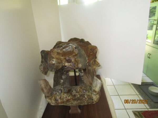 A stone sculpture sitting on top of a wooden floor.