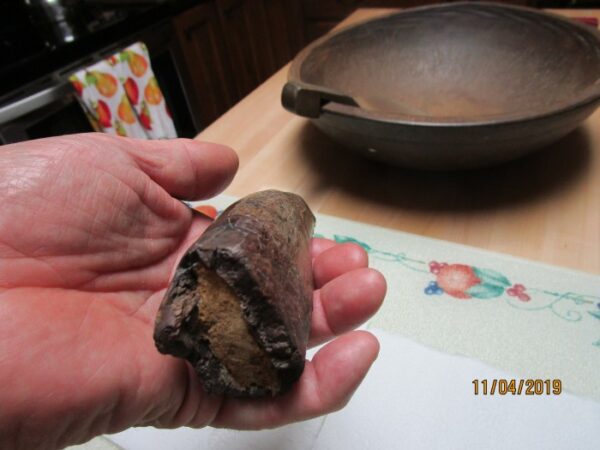 A person holding a piece of food in their hand.